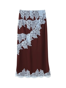Detailed view of dark brown satin skirt featuring delicate light blue lace flower patchwork