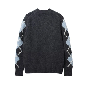 Detail view of the argyle pattern on dark grey knit cardigan with ribbed cuffs
