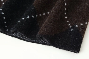 Detailed close-up showing thick wool-blend knit texture with brown diamond lattice patterns