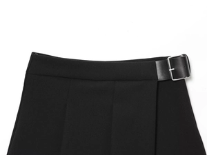 Détail du short noir avec ceinture en similicuir et boucle métallique argentée