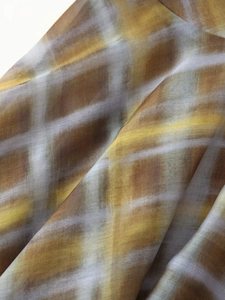 Detailed macro view of semi-transparent plaid organza fabric with ink painting texture
