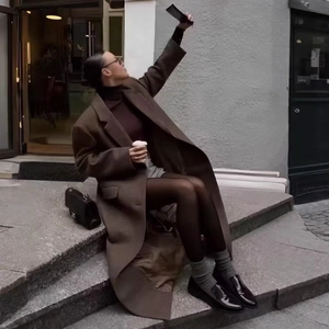Brown oversized wool coat featuring a long lapel design for an elegant autumn streetwear look