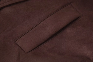 Detail of the welt pocket and neat stitching on dark brown faux suede long coat