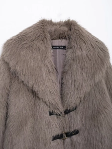 Close-up of grey faux fur coat featuring wide lapels and black leather buckle closures