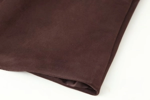Macro detail of dark brown velvet fabric and smooth satin lining on the coat sleeve