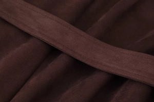 Detailed close-up of dark brown suede fabric texture and stitched belt workmanship