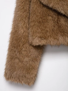 Close-up of the plush texture and warm brown faux fur fibers of the short jacket