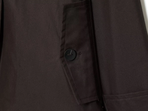 Detailed close-up of a waterproof parka jacket featuring a buttoned pocket and twill texture