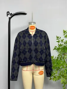 Detailed view of argyle knit cardigan with metal zipper and front patch pockets