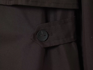 Detailed macro view of twill fabric texture and matte button on the parka sleeve cuff