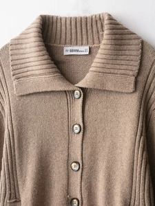 Close-up of the ribbed knit cardigan collar with buttons and white size label detail