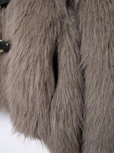 Detail of taupe faux fur coat texture with premium black leather buckle and metal fastener