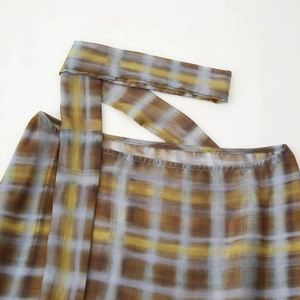 Classic yellow and brown plaid poncho top with decorative tie in a breathable fabric
