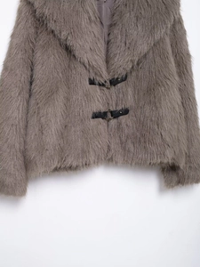 Close-up of faux fur texture with dark gray fibers and black leather metal ring buckles