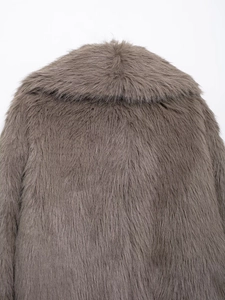 Close-up of the dense, soft grey-brown faux fur texture on the back of the short coat