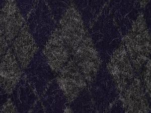Detailed close-up of dark purple and white argyle knit sweater with soft mohair texture