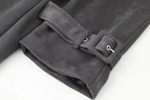 Detail shot of charcoal grey coat cuff with suede texture and square buckle strap