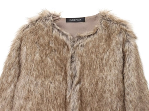 Detail of faux fur texture and brown silk lining on short jacket with brand label