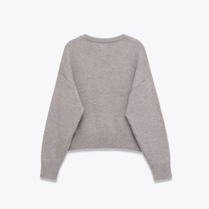 Light grey soft knit sweater with drop shoulder design and ribbed cuffs, back view