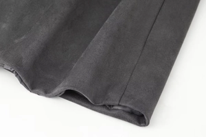 Close-up of dark grey suede coat cuff with smooth lining and neat stitching detail
