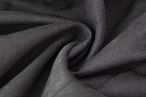 Close-up of deep grey wool blend fabric showing soft brushed texture and matte finish
