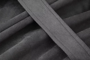 Macro shot showing double-stitched seams and soft wool-like texture of the long coat