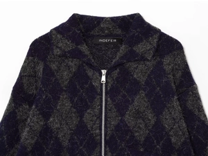 Detail of argyle knit cardigan with silver zipper and INDEFEIR brand neck label