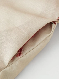 Detailed close-up of textured cotton fabric and floral embroidery on jacket pocket