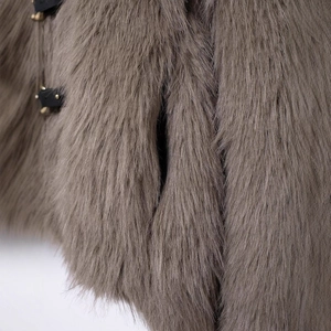 Faux fur short coat featuring luxurious brown texture with leather straps and gold buckles