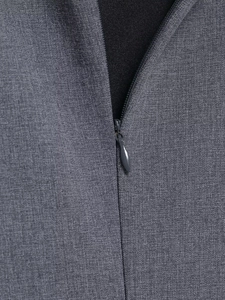 Detailed close-up of invisible zipper and woven grey fabric texture on the midi dress