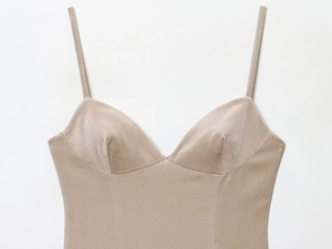 Détail d'une robe en velours beige avec de fines bretelles et un col en V