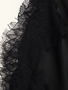 Detailed close-up of intricate black eyelash lace and smooth satin fabric texture