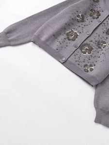 Detail of grey knitted cardigan with handmade floral sequin and bead embellishments