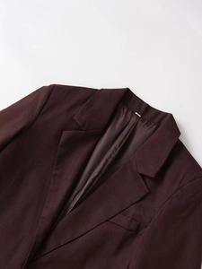 Detail of notch lapel and brown linen blend fabric with satin lining on blazer