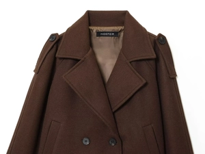 Detail of deep brown double-breasted wool coat with notch lapels and shoulder epaulets
