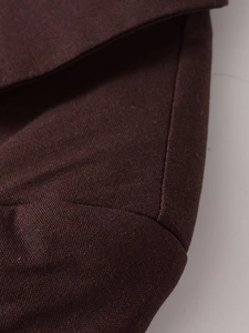 Macro view of burgundy linen-blend blazer fabric showing high-quality twill texture
