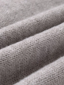 Detail shot of soft grey knit fabric texture with fine wool fibers and smooth weave