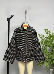 Detail of black and white plaid tweed jacket with lapel collar and vintage buttons