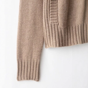 Brown knit cardigan featuring high-quality ribbed trim and fine woven wool texture