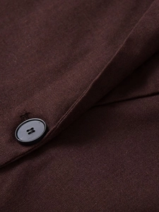 Detailed macro view of dark brown linen blend blazer with black matte button detail