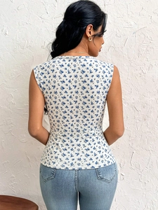 Rear view of a white slim-fit tank top with blue floral print and round neck detail