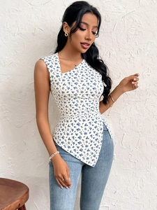 Detailed close-up of white off-shoulder slim top with blue floral print and ruffled hem