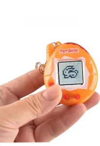 Handheld orange electronic pet game console with pixel LCD screen and keychain