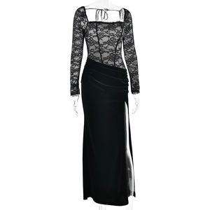 Detail of elegant black lace bodice and high slit velvet evening dress with floral pattern