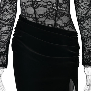 Detail of black lace bodice joined with draped velvet skirt on high slit evening dress