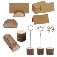 Selection of rustic wooden place card holders with kraft paper cards for wedding events