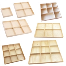 Detail of various multi-compartment boxwood wooden organizer trays for home storage