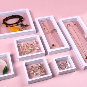 White PE film floating jewelry box set for rings and necklaces on pink background