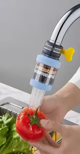 Rotating kitchen tap filter showing water-saving spray head washing fresh tomatoes
