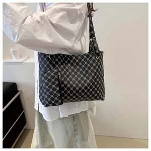 Detail of black printed tote bag set with matching small zipper pouch and gold hardware